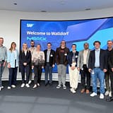 Teilnehmende des SAP-Expertenworkshops zu KI in regulierten Pharma-Prozessen vor der Begruessungswand in Walldorf, 18. August 2026